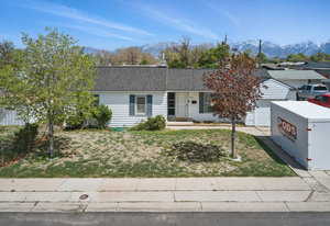 Ranch-style house with a mountain view, a garage, and concrete driveway