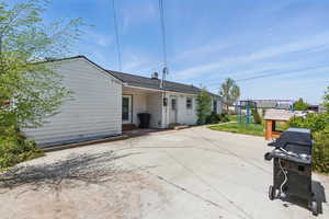 Rear view of house with a playground, entry steps, and a patio area