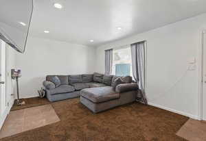 Carpeted living room with recessed lighting