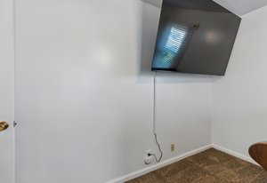 Detailed view of carpet flooring and baseboards