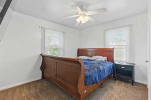 Bedroom featuring baseboards, ceiling fan, and carpet