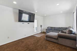 Living room with recessed lighting and carpet floors