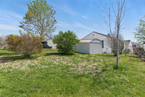 View of yard featuring an outdoor structure and a pole building