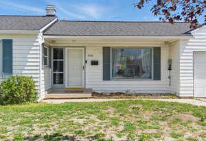 View of front facade featuring an attached garage and a porch