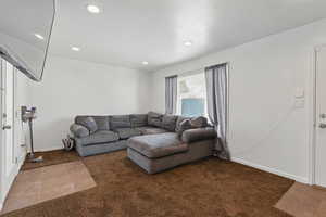 Living room featuring recessed lighting, carpet flooring, and baseboards