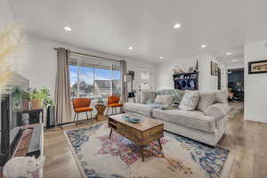 Living area featuring wood finished floors, recessed lighting, and baseboards