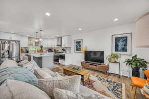 Living room with recessed lighting, baseboards, and light wood-type flooring