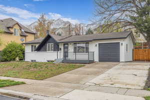 Single story home with a garage, fence, a front yard, and concrete driveway