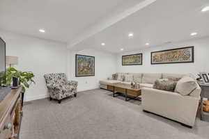 Living room featuring carpet, recessed lighting, and baseboards