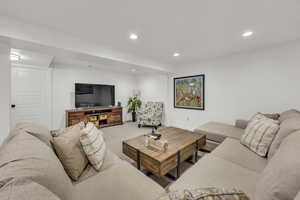 Carpeted living area featuring recessed lighting