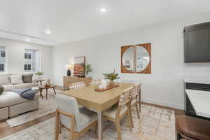 Dining room featuring baseboards, light wood-type flooring, and recessed lighting