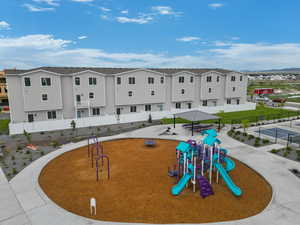Community playground featuring fence, a residential view, and a mountain view