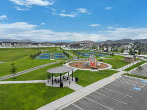 View of home's community featuring a gazebo, a residential view, a lawn, and uncovered parking