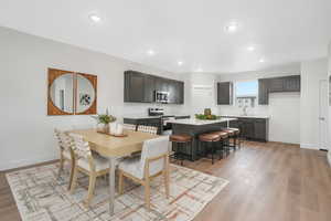 Dining room featuring recessed lighting, baseboards, and light wood-type flooring