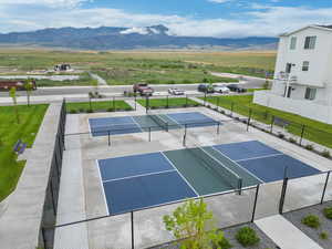 View of tennis court featuring fence and a mountain view