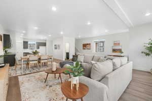 Living area featuring light wood-style flooring, baseboards, and recessed lighting