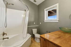 Full bathroom with visible vents, tile patterned flooring, vanity, toilet, and shower / bathtub combination with curtain
