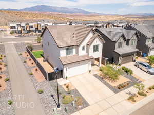 View of front of home with stucco siding, a tiled roof, a residential view, and a garage