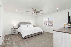 Bedroom featuring light colored carpet, visible vents, recessed lighting, and baseboards