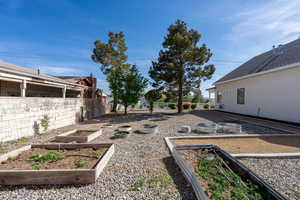 View of yard with a fenced backyard and a vegetable garden