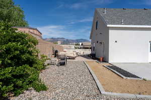 View of yard featuring a patio, a mountain view, and a fenced backyard