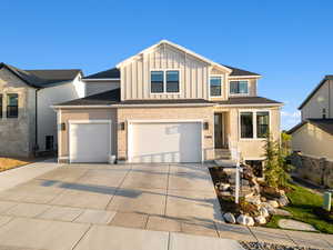 View of front of property featuring a garage, board and batten siding, and concrete driveway