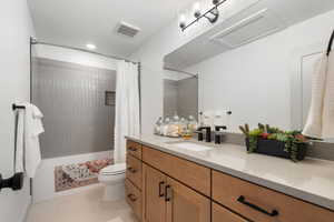 Bathroom with shower / bath combo, vanity, toilet, recessed lighting, and visible vents