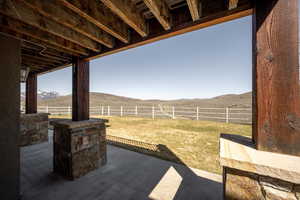 View of yard with a mountain view, a fenced backyard, and a patio area