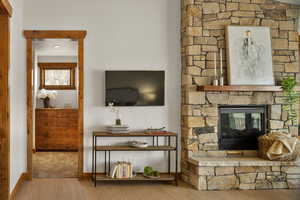 Living room featuring baseboards, a fireplace, and wood finished floors
