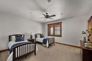 Bedroom featuring baseboards, visible vents, light carpet, and ceiling fan