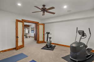 Exercise area featuring baseboards, a ceiling fan, recessed lighting, and light carpet