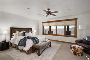 Bedroom featuring baseboards, multiple windows, light carpet, and a ceiling fan