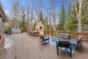 Wooden deck with an outdoor living space with a fireplace
