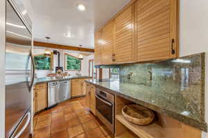 Kitchen with recessed lighting, a sink, stainless steel appliances, decorative backsplash, and light tile patterned floors