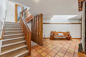 Stairs featuring tile patterned floors and baseboards