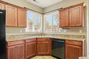 Kitchen with visible vents, a sink, plenty of natural light, and black appliances