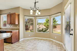 Interior space featuring plenty of natural light, stone tile flooring, and visible vents