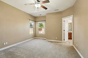 Unfurnished bedroom with baseboards, light colored carpet, and visible vents