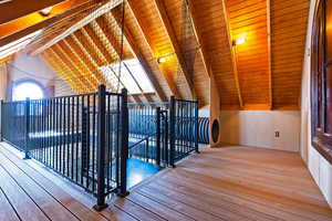 Interior space featuring wood ceiling, vaulted ceiling with beams, and hardwood / wood-style floors