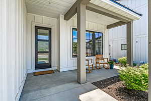 Doorway to property with board and batten siding