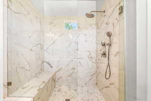 Full bath featuring a marble finish shower
