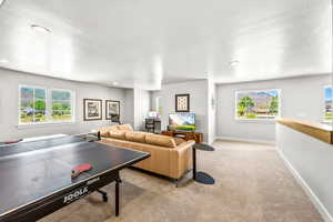 Rec room with light colored carpet, recessed lighting, and baseboards