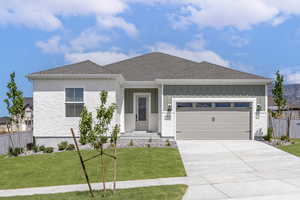 View of front facade featuring board and batten siding, fence, and a front yard