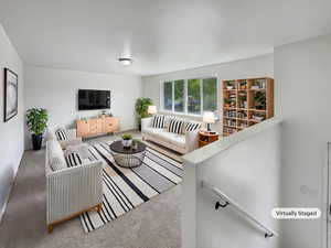 Carpeted living room featuring baseboards
