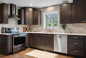 Kitchen with a sink, light wood-style floors, stainless steel appliances, dark brown cabinetry, and wall chimney exhaust hood