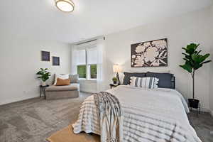 Carpeted bedroom featuring baseboards