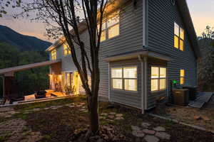 Rear view of house featuring a mountain view, a patio, and central AC