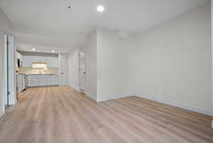 Unfurnished living room with baseboards, recessed lighting, and light wood finished floors