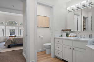 Master Bathroom with toilet, baseboards, vanity, and ensuite bath