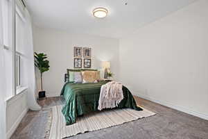 Carpeted bedroom featuring baseboards